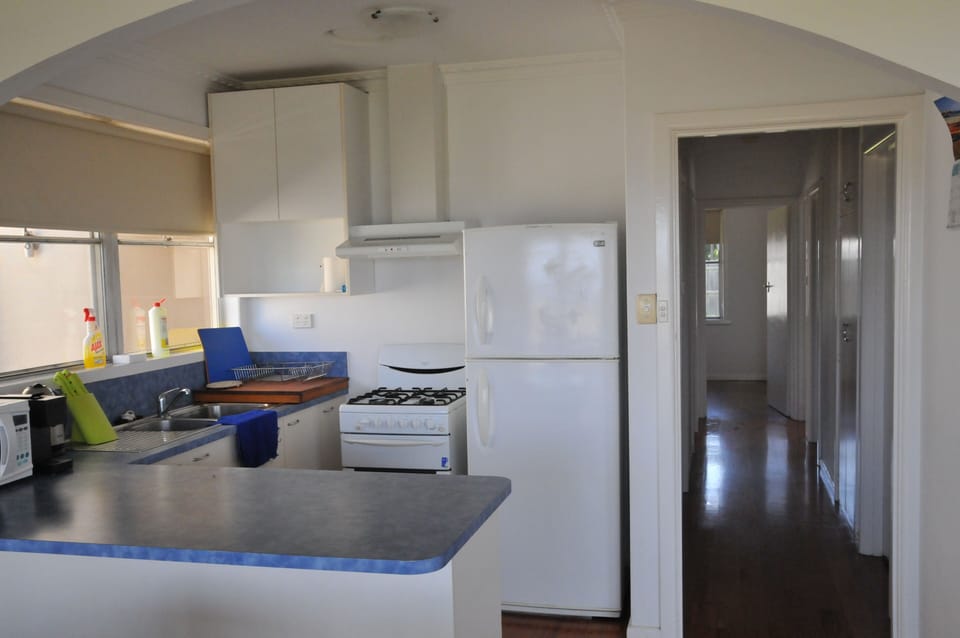 Kitchen with microwave. Fridge, electric kettle, Aldi K express coffee machine.