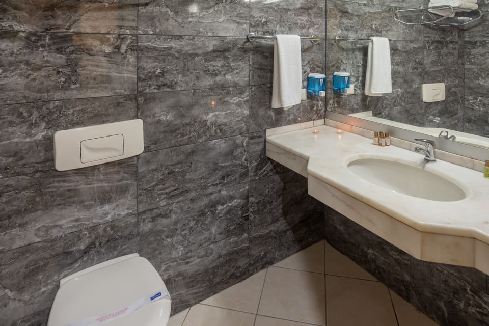 Shower, rainfall showerhead, hair dryer, towels