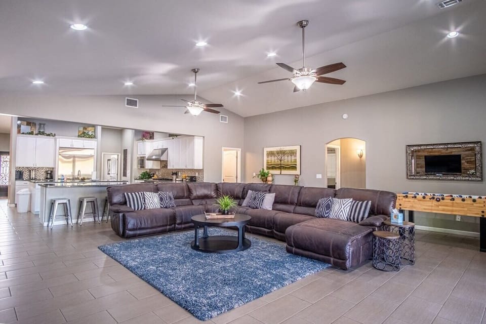 Great Room with Curved HD Smart TV looks out onto the patio & pool area