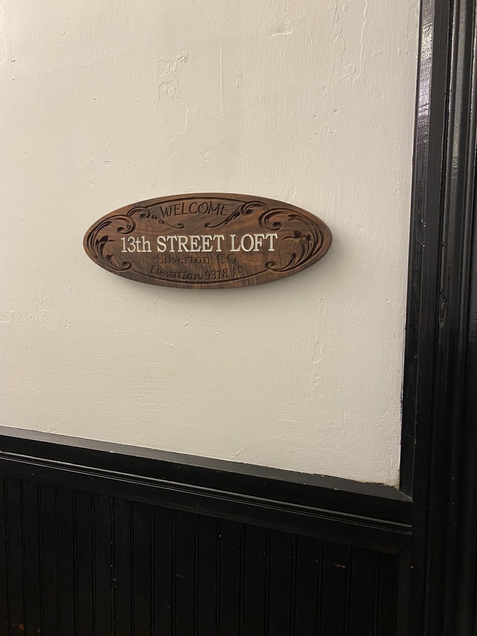 Sign for the 13th Street Studio Loft in upstairs hallway.