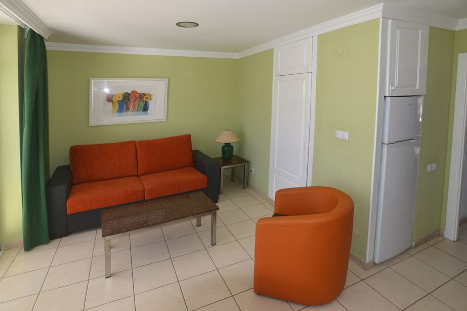 Apartment, 1 Bedroom, Balcony, Pool View | Living area | Flat-screen TV
