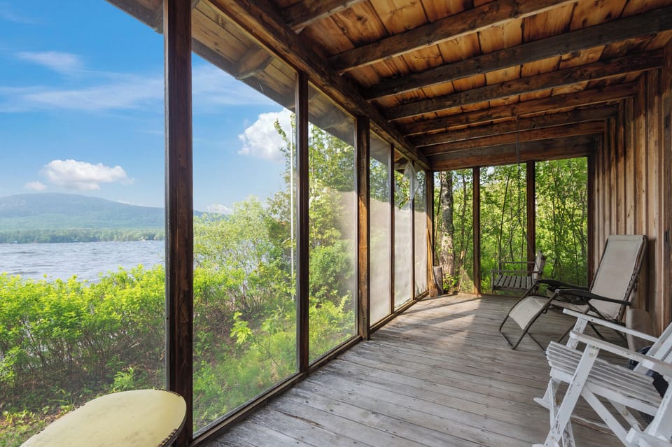 Boat House Screened Porch with chairs and beautiful lake views