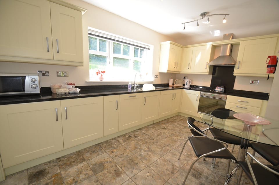 The bright Kitchen has all modern built in appliances and a dining table for 4