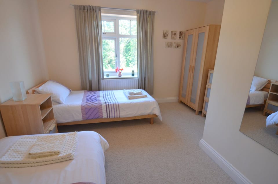 The second bedroom is a spacious twin with two wardrobes and a chest of drawers