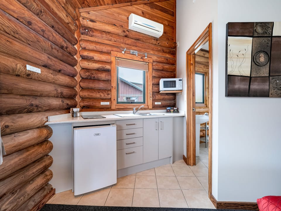 King Beachfront Chalet | Private kitchen | Fridge, electric kettle