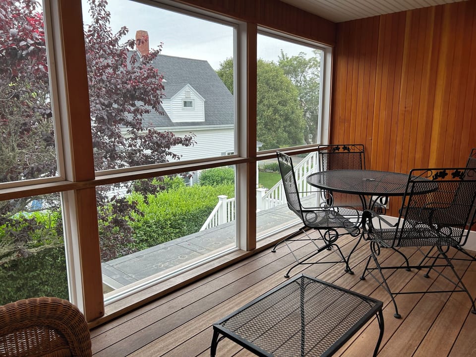 Porch has glass lower panels and screens above