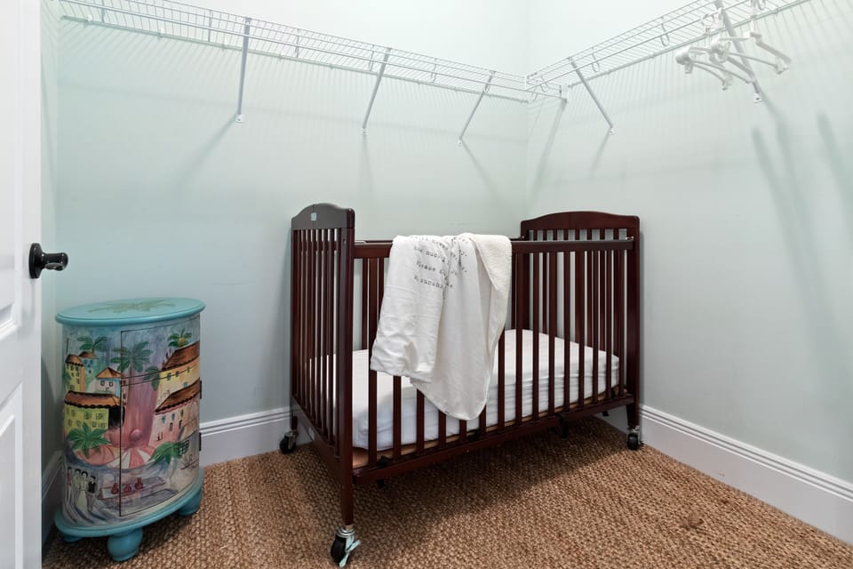 Full crib in large closet.  HVAC vent and power outlet for baby monitor.