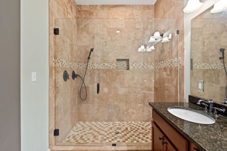 Very large shower with two shower heads.  One removable to be used for kids.