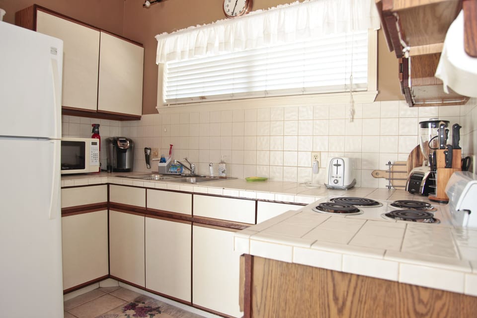 Kitchen has every utensil and appliance aside from a dishwasher.