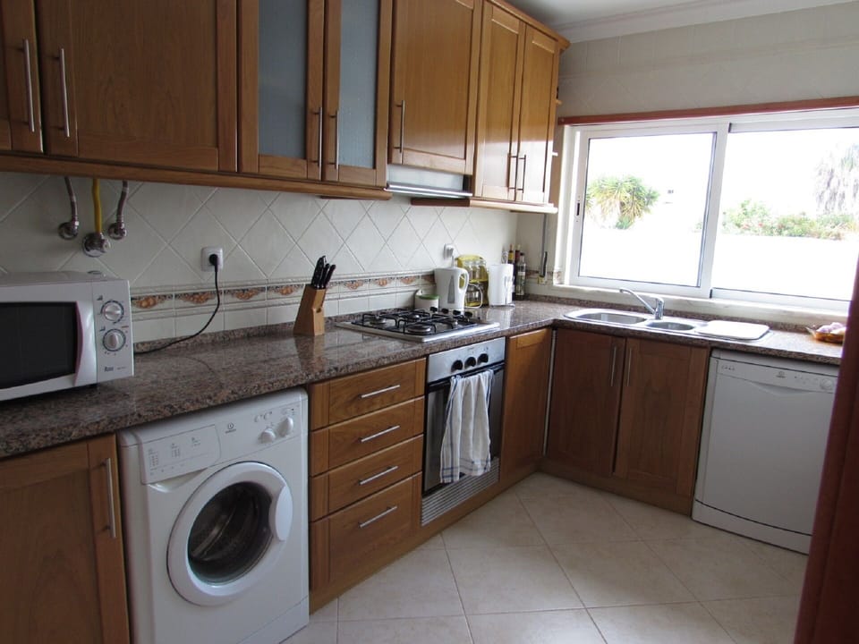 Kitchen with washing machine, dishwasher and fridge/freezer