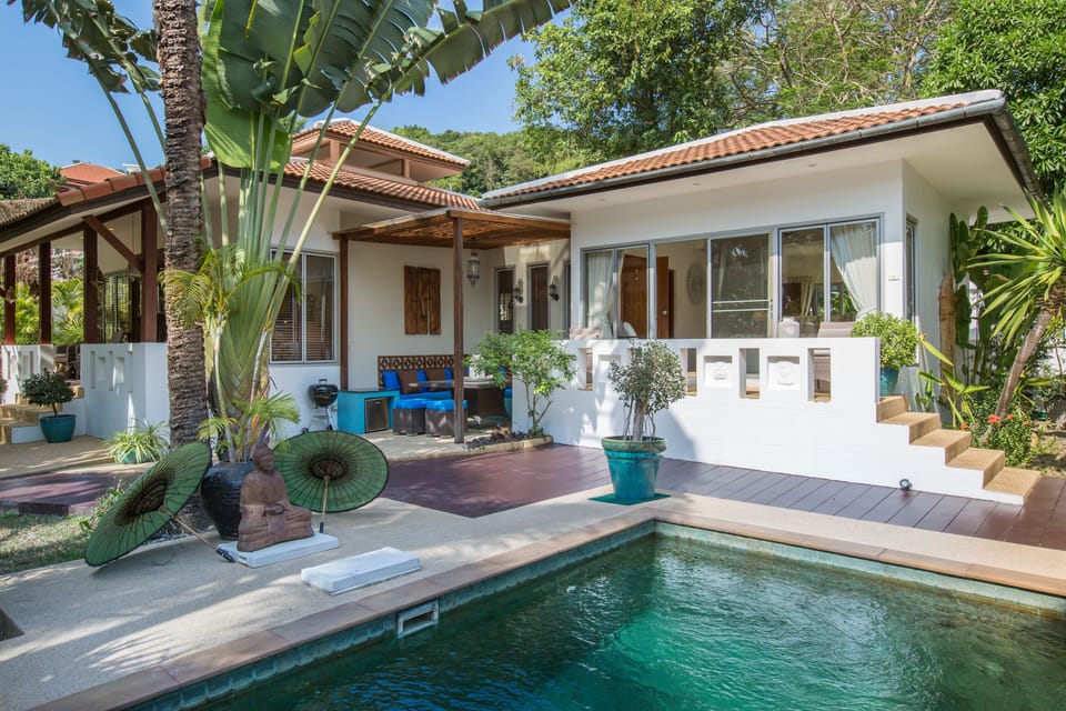 Out door covered sala area with large seating, dining table and BBQ