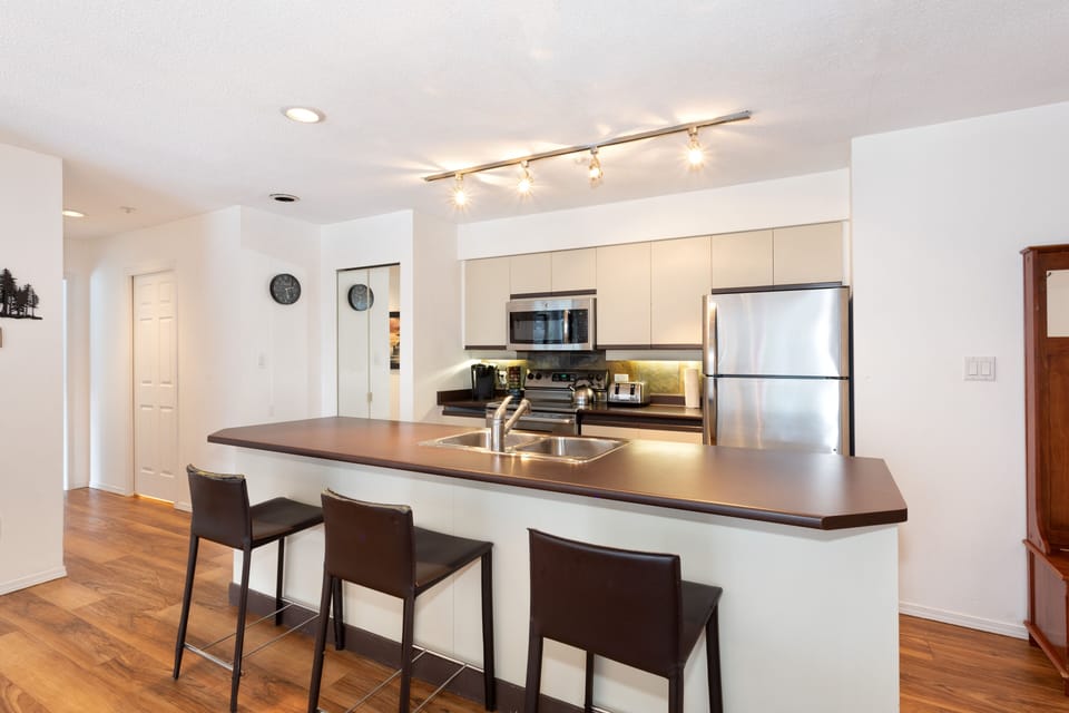 Kitchen with bar stool seating for three at island 