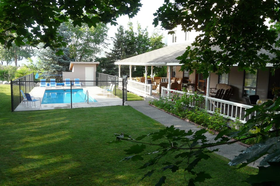 Watch all the pool action from the 12' wrap around porch.  Pool heated to 85