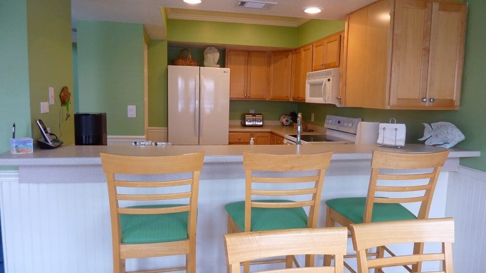 Full kitchen well stocked just bring your food. View into kitchen from dining. 