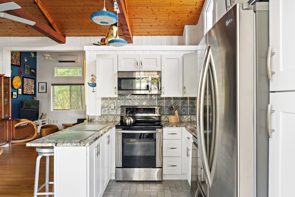 Full kitchen with stove, refrigerator, microwave, and dishwasher and granite.