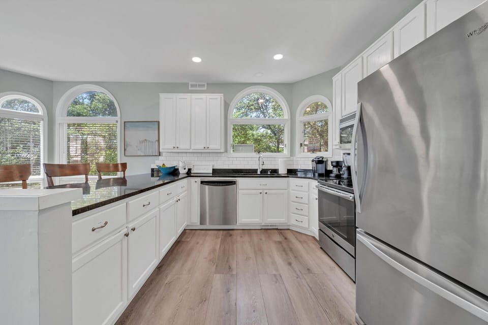 Professional kitchen with granite tops and stainless steel appliances
