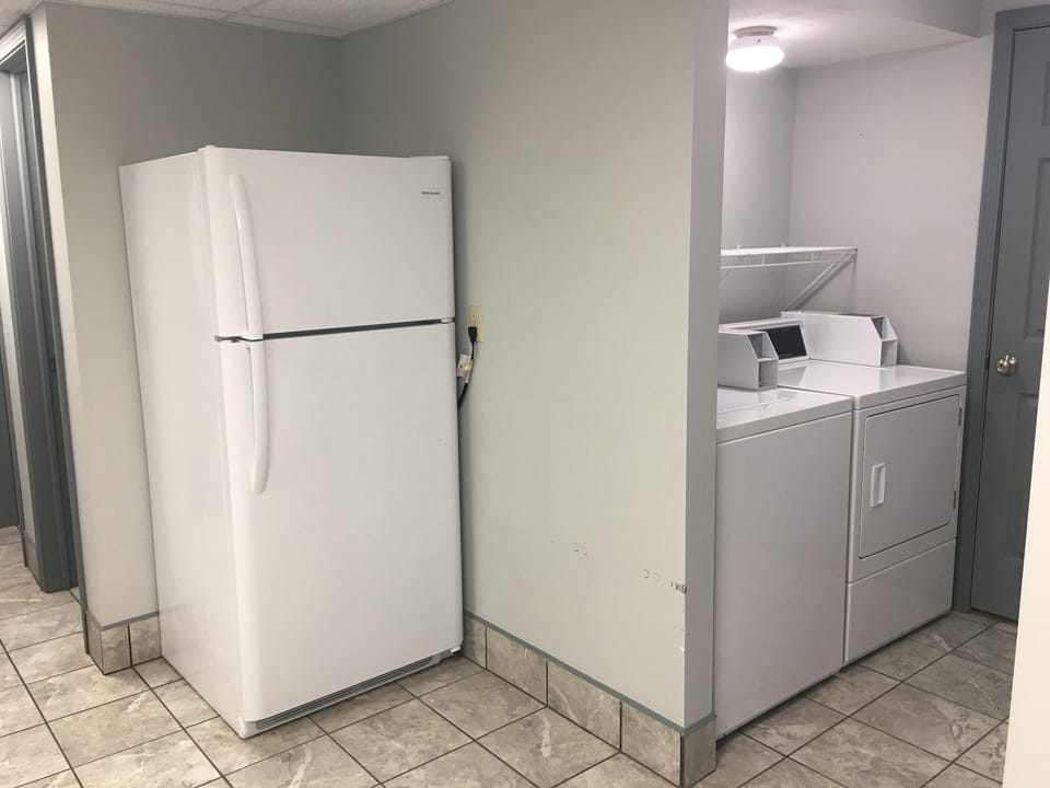 Additional refrigerator and coin laundry in basement. Outside entrance.