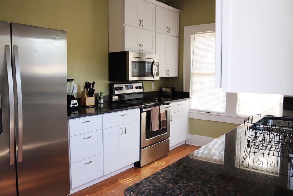 Kitchen with microwave, stove, oven, blender, toaster.
