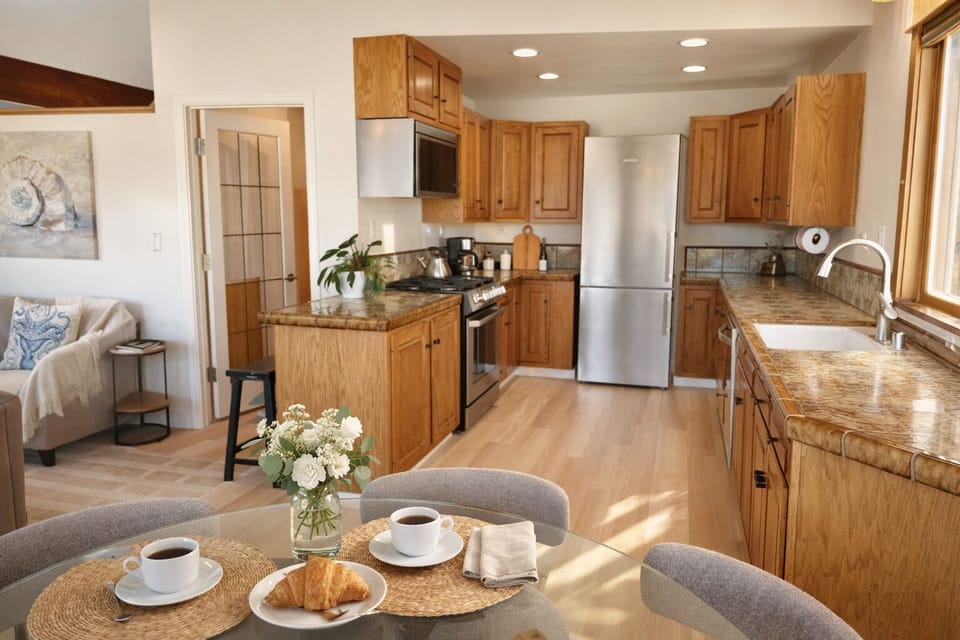 Open kitchen with breakfast setup and coastal light