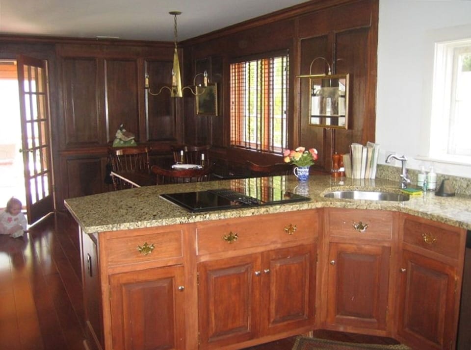 Fully equipped kitchen adjacent panelled Family Room with informal eating area  