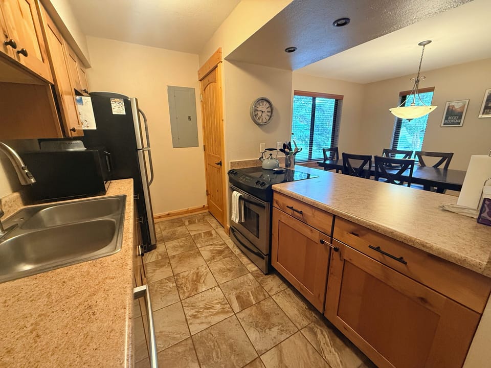 Full kitchen with oven, stovetop, fully stocked pots, pans, and pantry.