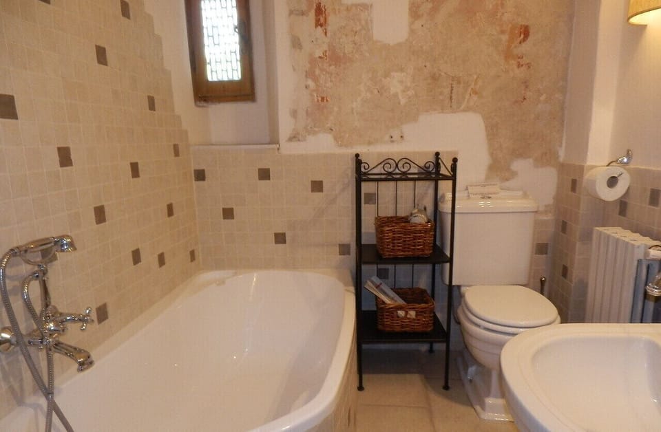 Bathroom Patrik with bath tub. In the back wall 14th century fresco !