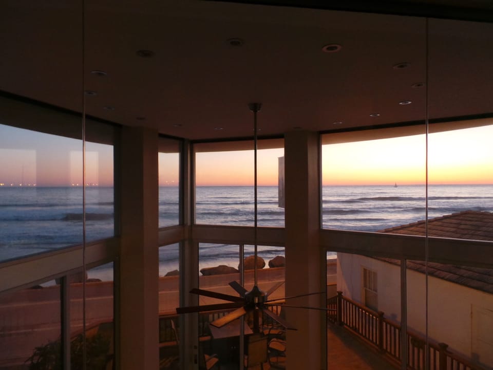 The ocean view from the upper level master bedroom at dusk.