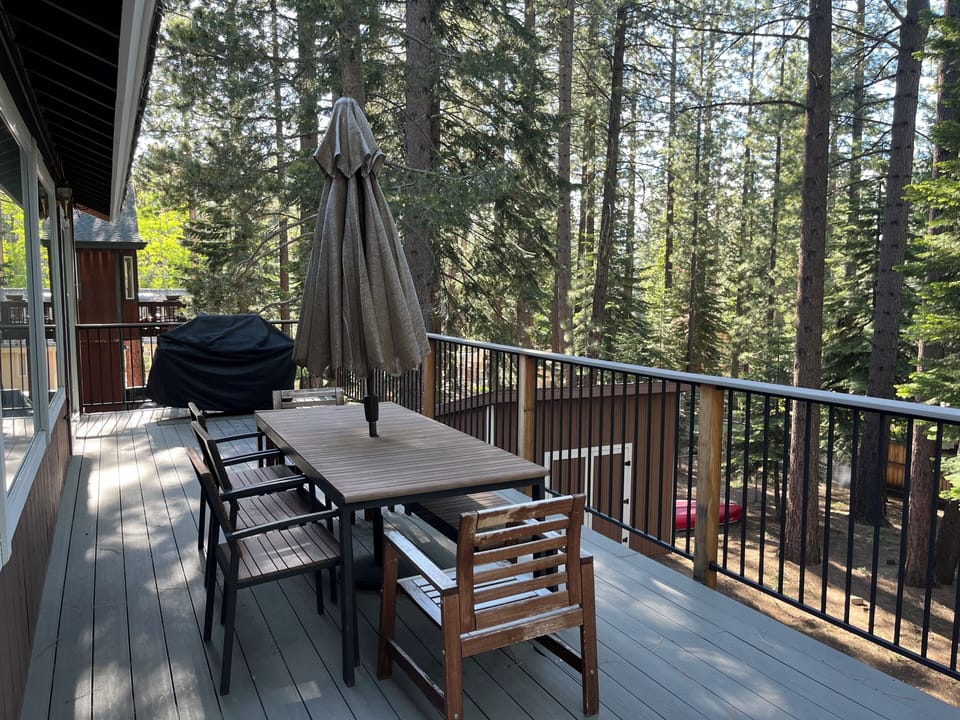 Large deck with Forest views and dining area. 