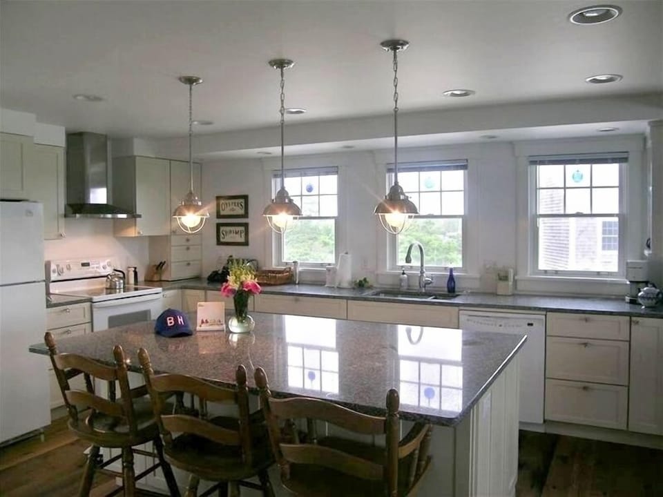 Kitchen with center island and quartz countertops