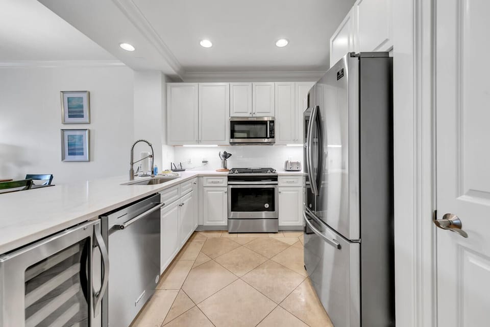 Bright updated kitchen with stainless appliances and wine cooler.