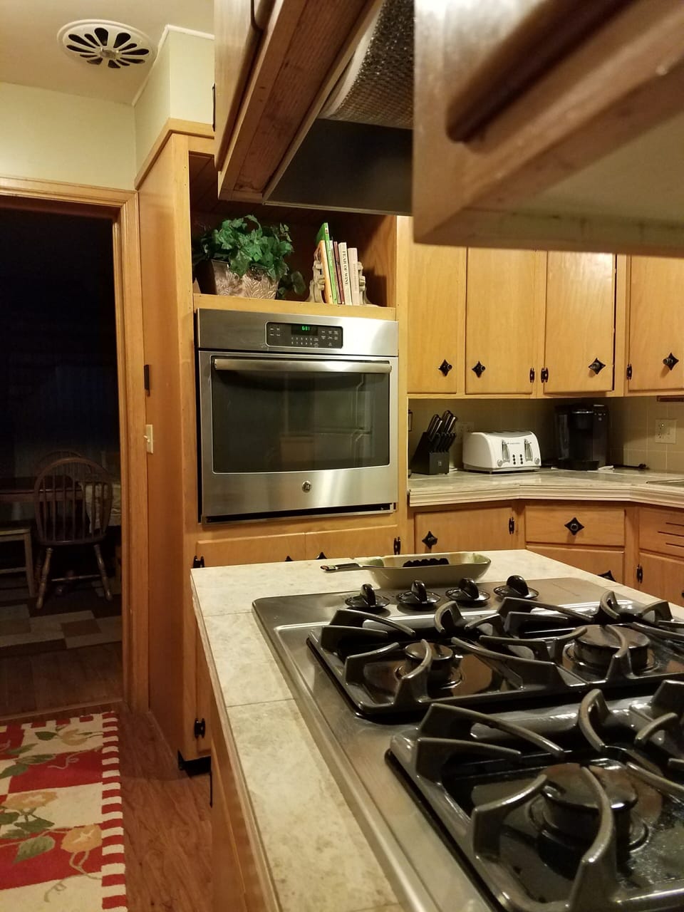 Updated kitchen with gas cooktop, new wall oven, and marble tiled countertops