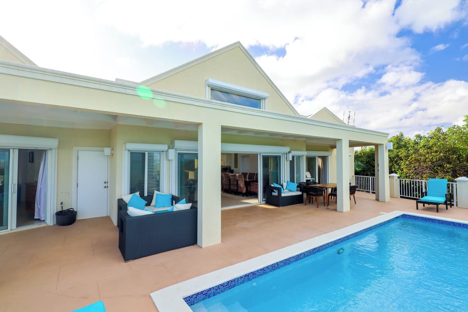 Enjoy pool deck with lounge chairs, loveseats, outdoor grill & dining for 6.