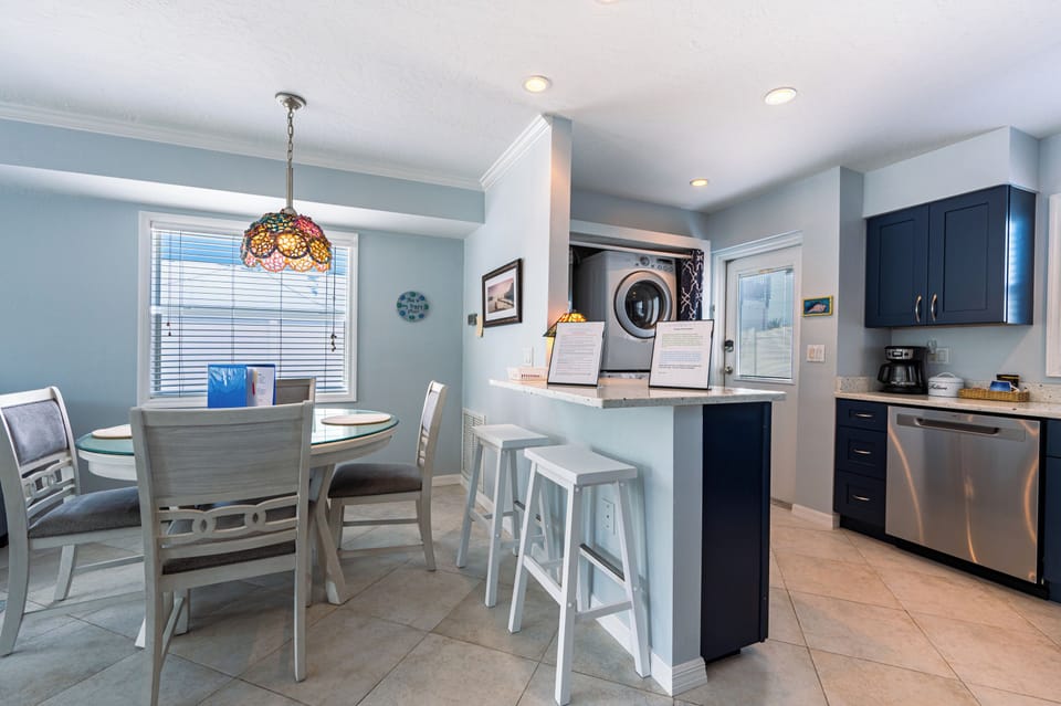 Kitchen/ Dining with breakfast bar and front load washer dryer.