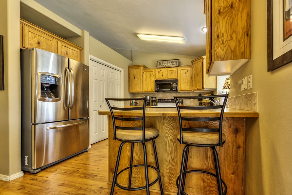Breakfast bar with barstools, stainless steel refridgerator