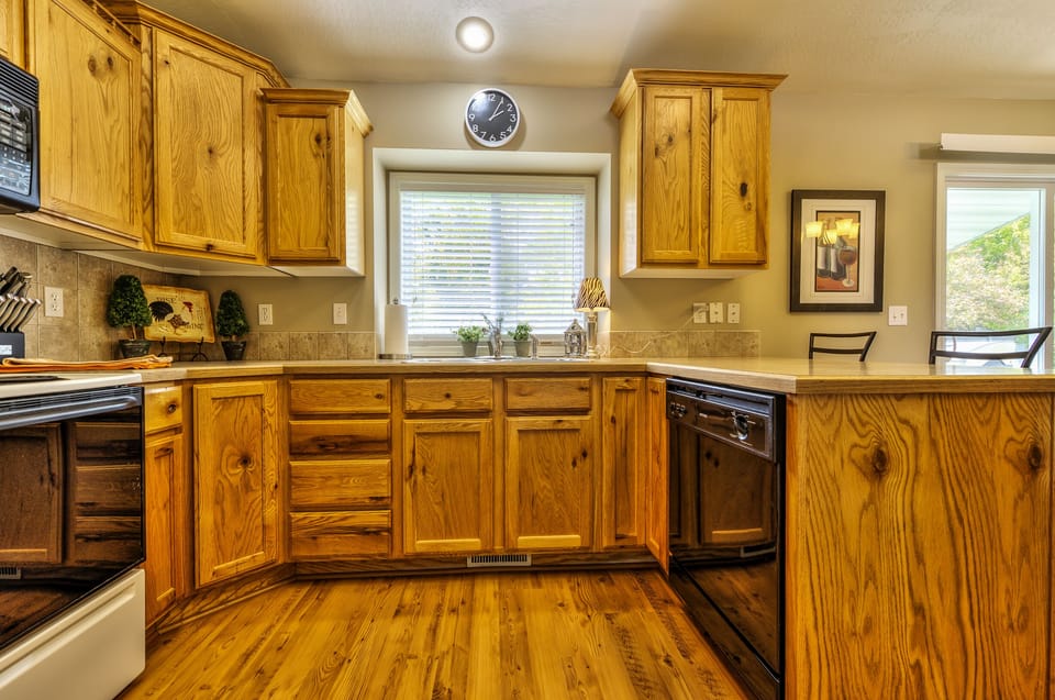 fully stocked kitchen with Microwave, dishwasher, electric range and oven.