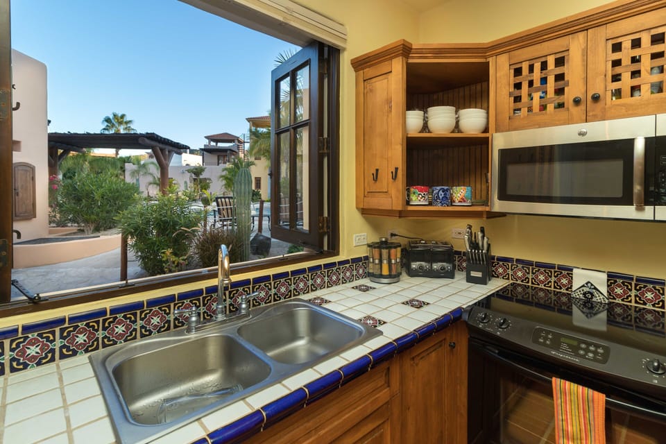 Large window opens up from the kitchen to the pool.