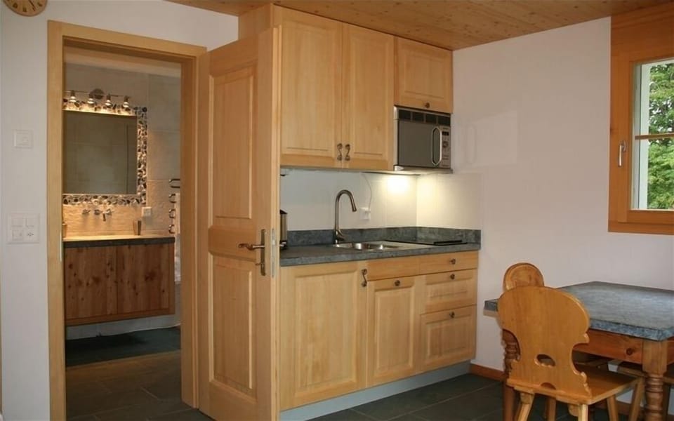 Kitchen area with natural soap stone countertops.