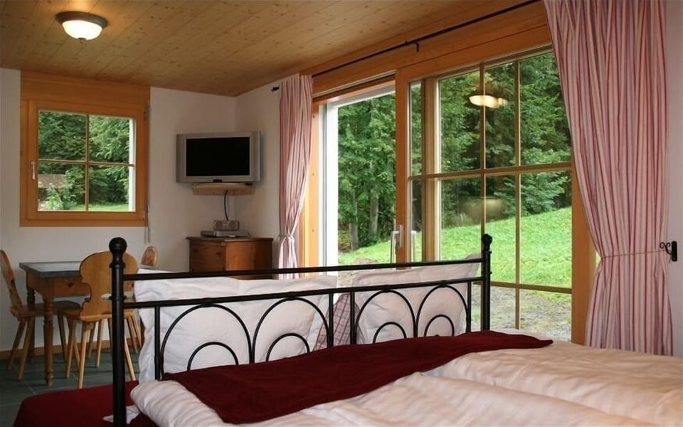 Living area with bed. Natural slate floors.