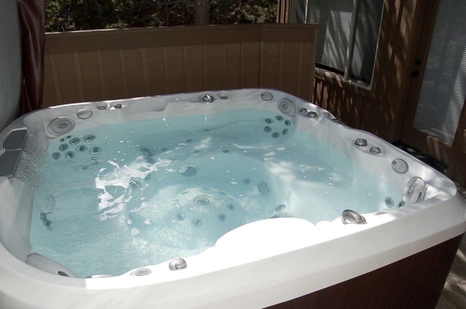 Hot tub with waterfalls.  Comfortably accommodates six adults.