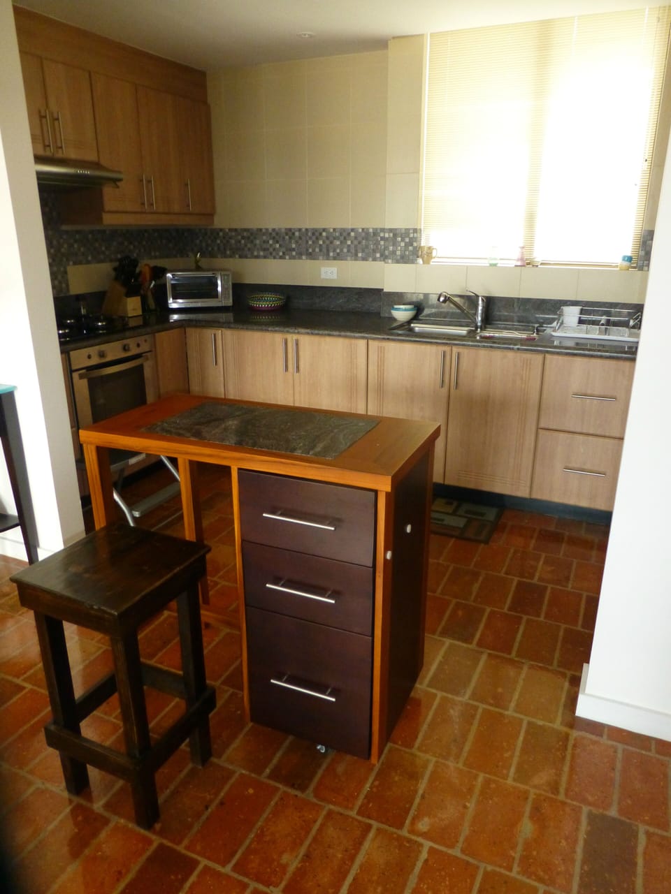 Kitchen with movable granite topped island