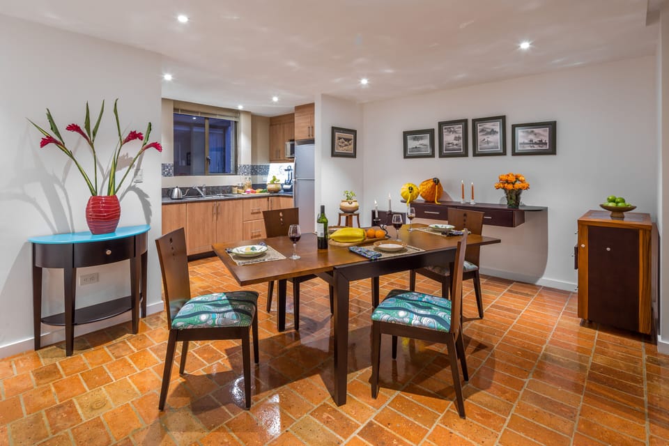 Dining room with kitchen in the background