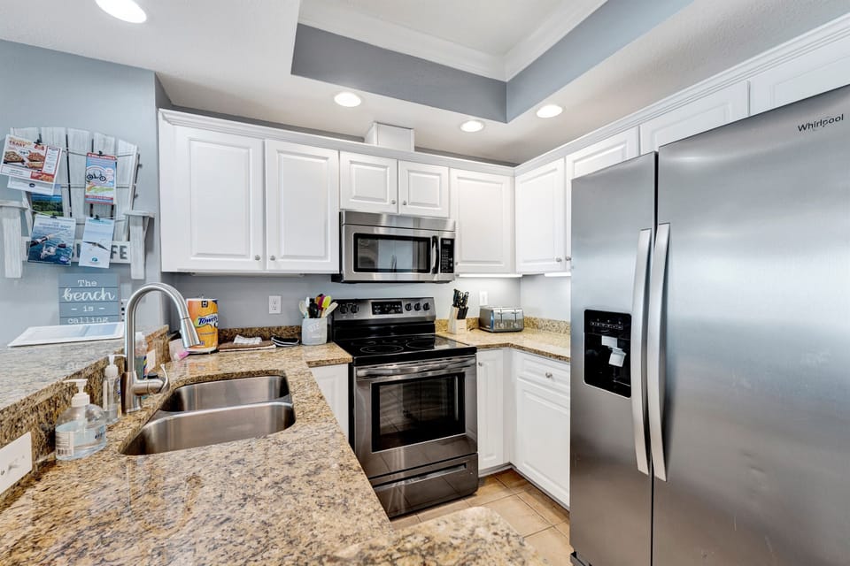 Kitchen with granite tops, stainless steel appliances, pots, pans, silverware, coffee maker, blender etc......