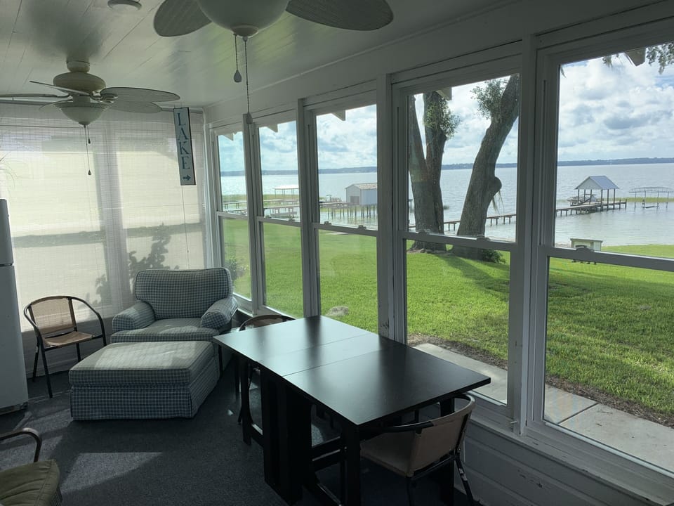Enclosed back porch w/ refrigerator.
