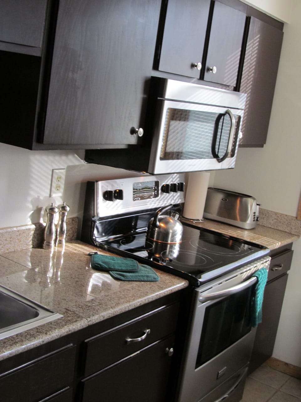 Granite counter tops, stainless appliances, tile floors in the galley kitchen.  