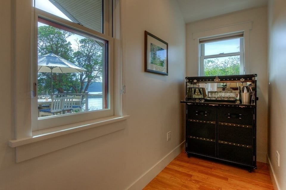 Hallway nook with leather bar provides glassware, decanter and bar ware.