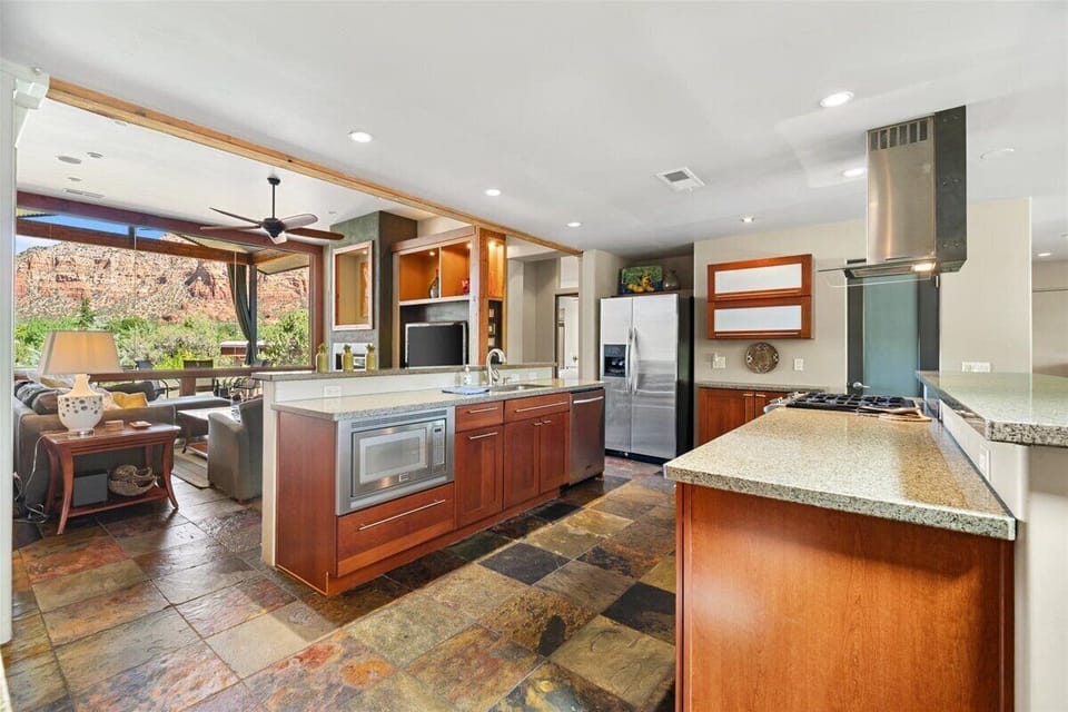 Fully stocked kitchen open to the den and the views.