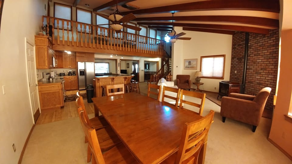 Large open area with dining, kitchen, sitting area, living room, mezzanine.