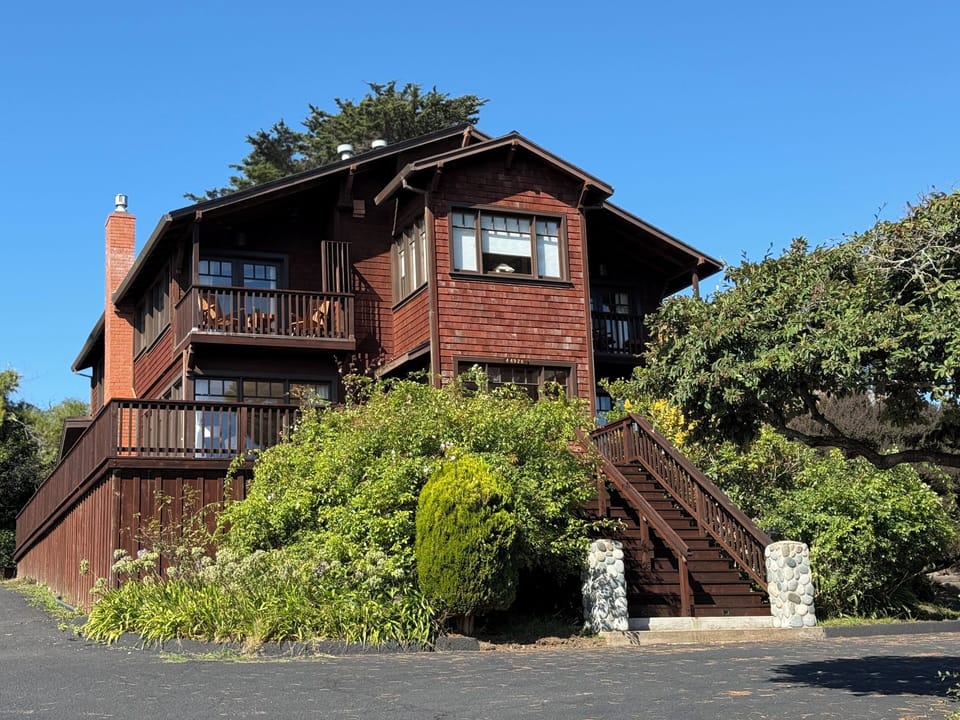 Exterior front view of the building. Ground unit is a private residence.