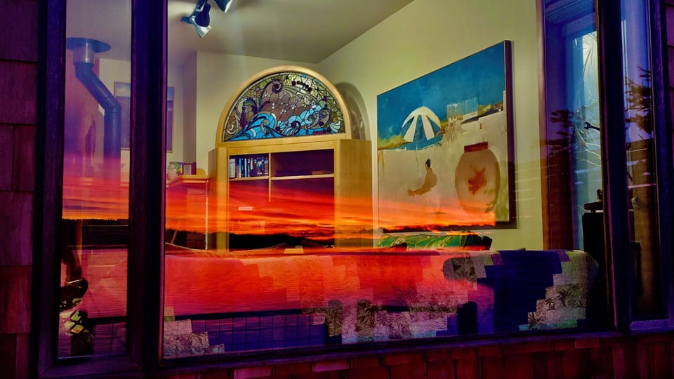 From the outside: sunset reflected in new window to living area.