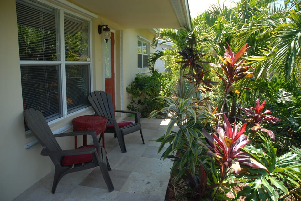 Relax on covered front porch with cascading water fountain & wind chimes.